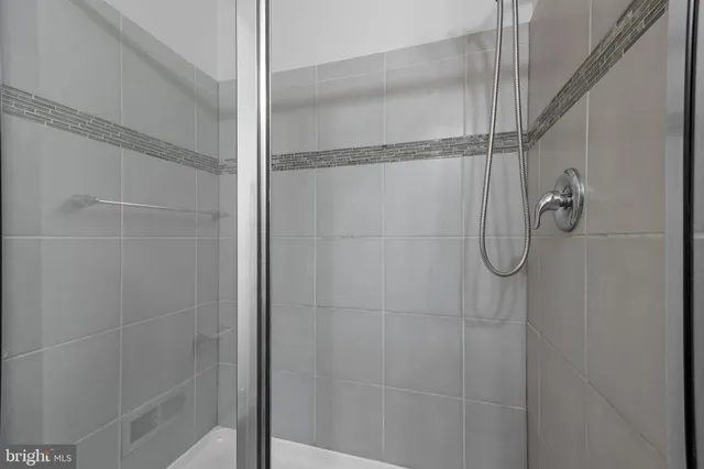 a bathroom with a glass shower door