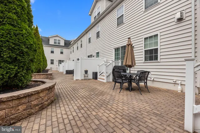 a view of a patio with table and chairs and potted plants