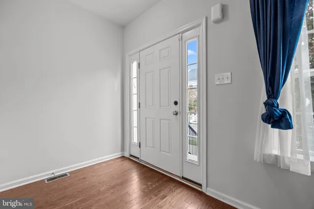 a view of an entryway with wooden floor
