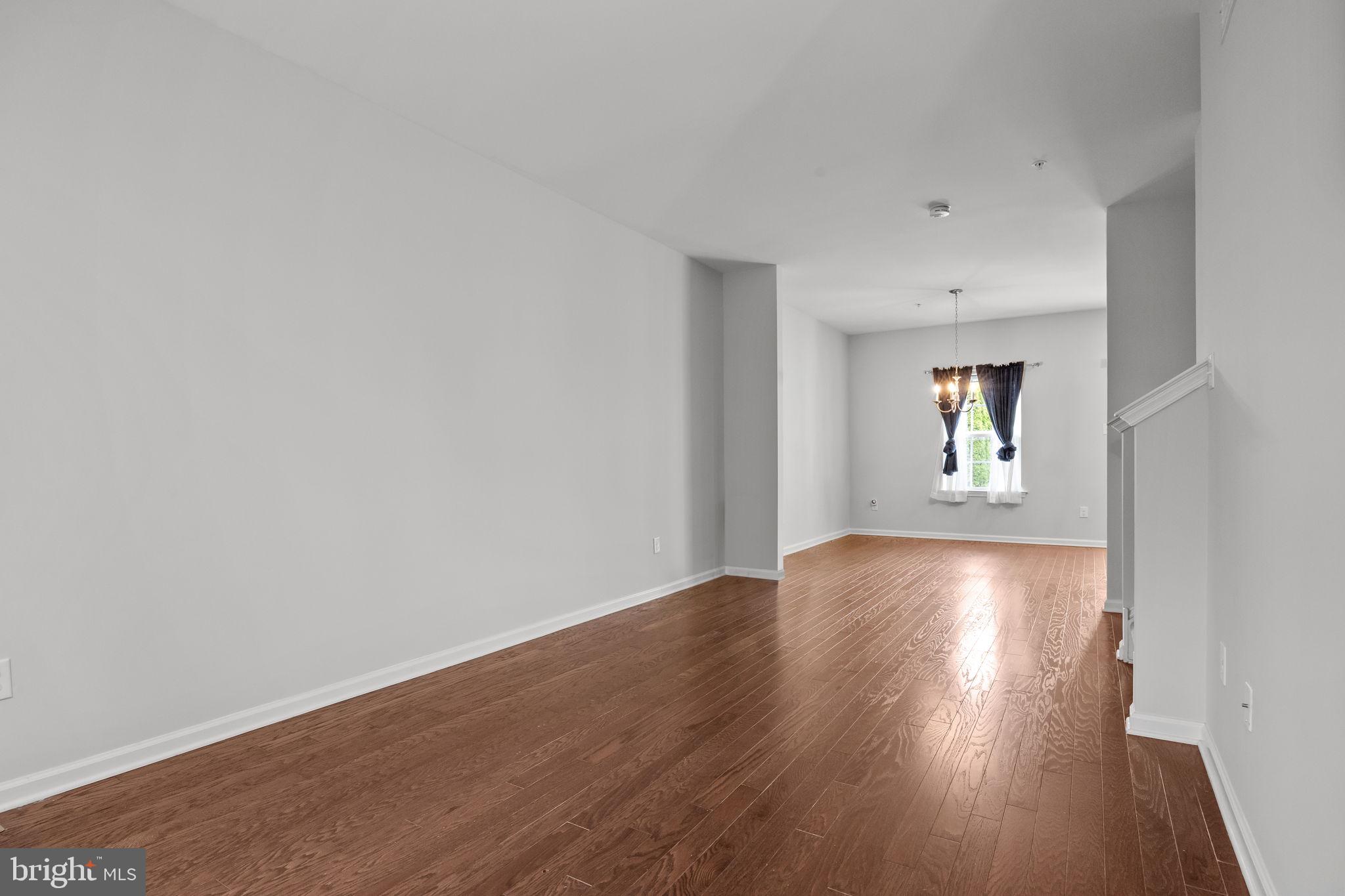 3799 Jacob Stout Road, Unit 2 Doylestown, PA 18902 - Photo 5 of 32 an empty room with wooden floor and windows