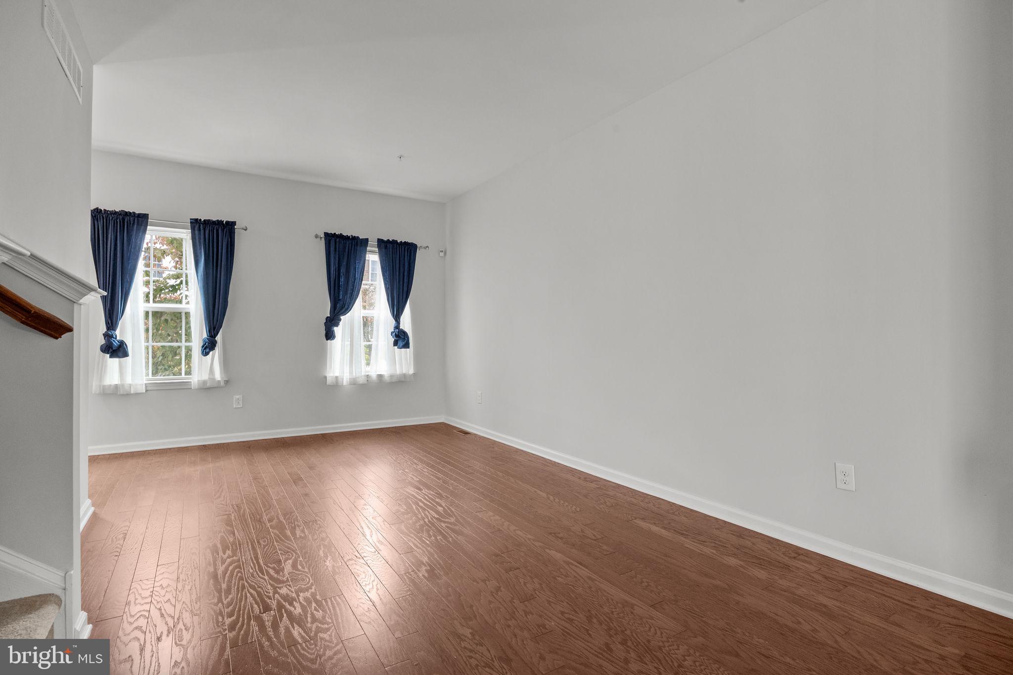 3799 Jacob Stout Road, Unit 2 Doylestown, PA 18902 - Photo 6 of 32 an empty room with wooden floor and windows