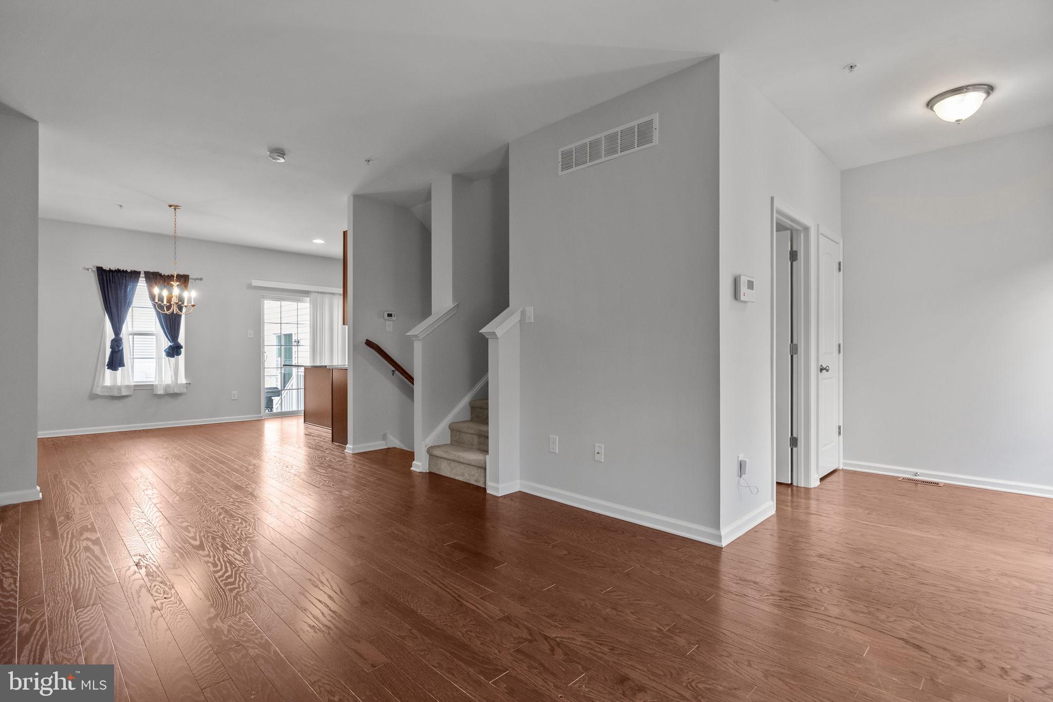 3799 Jacob Stout Road, Unit 2 Doylestown, PA 18902 - Photo 7 of 32 an empty room with wooden floor and windows
