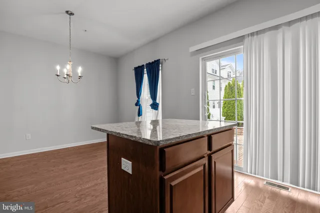 a kitchen with a granite countertop sink and a window