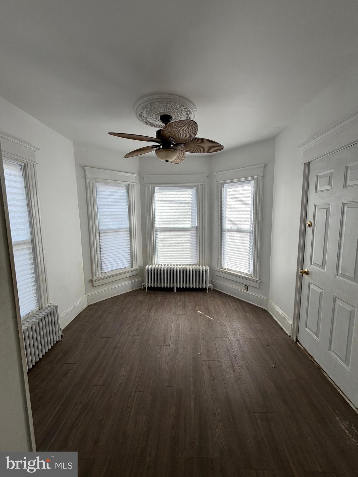 26 Walnut Street Bridgeton, NJ 08302 - Photo 16 of 22 an empty room with wooden floor and windows