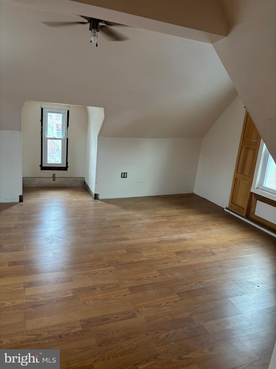 26 Walnut Street Bridgeton, NJ 08302 - Photo 6 of 22 an empty room with wooden floor and windows