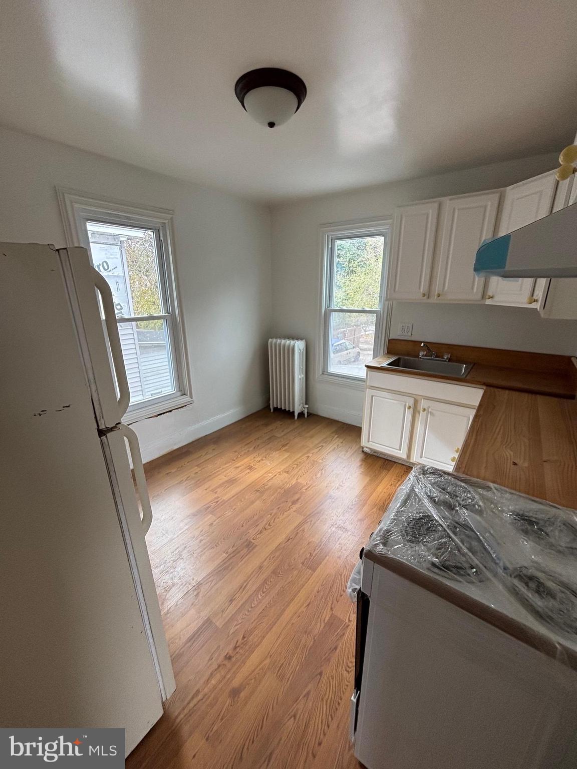 26 Walnut Street Bridgeton, NJ 08302 - Photo 9 of 22 a kitchen with granite countertop a stove and wooden floor