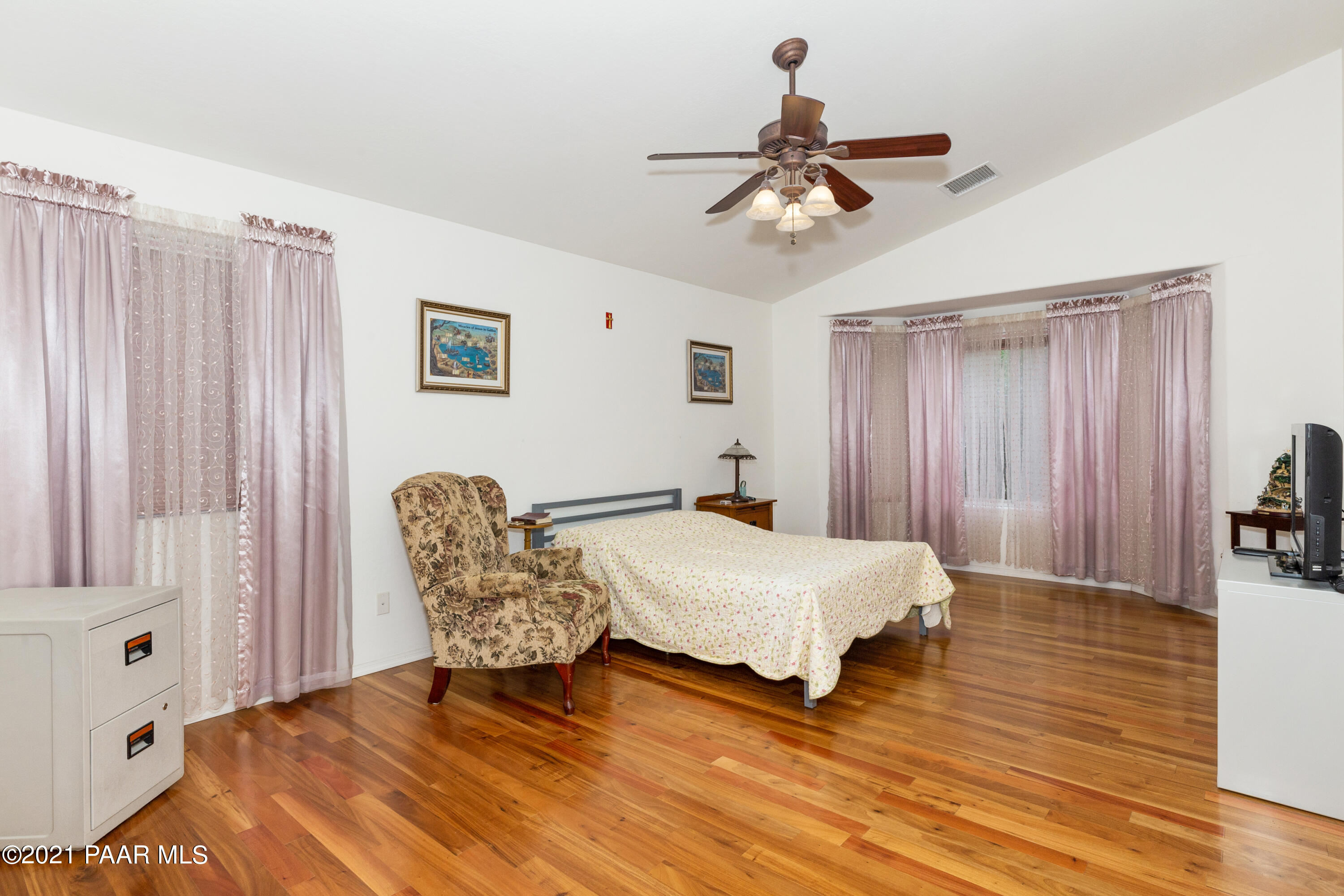 1654 St Andrews Way Prescott, AZ 86301 - Photo 11 of 29 a bedroom with a bed and a chandelier