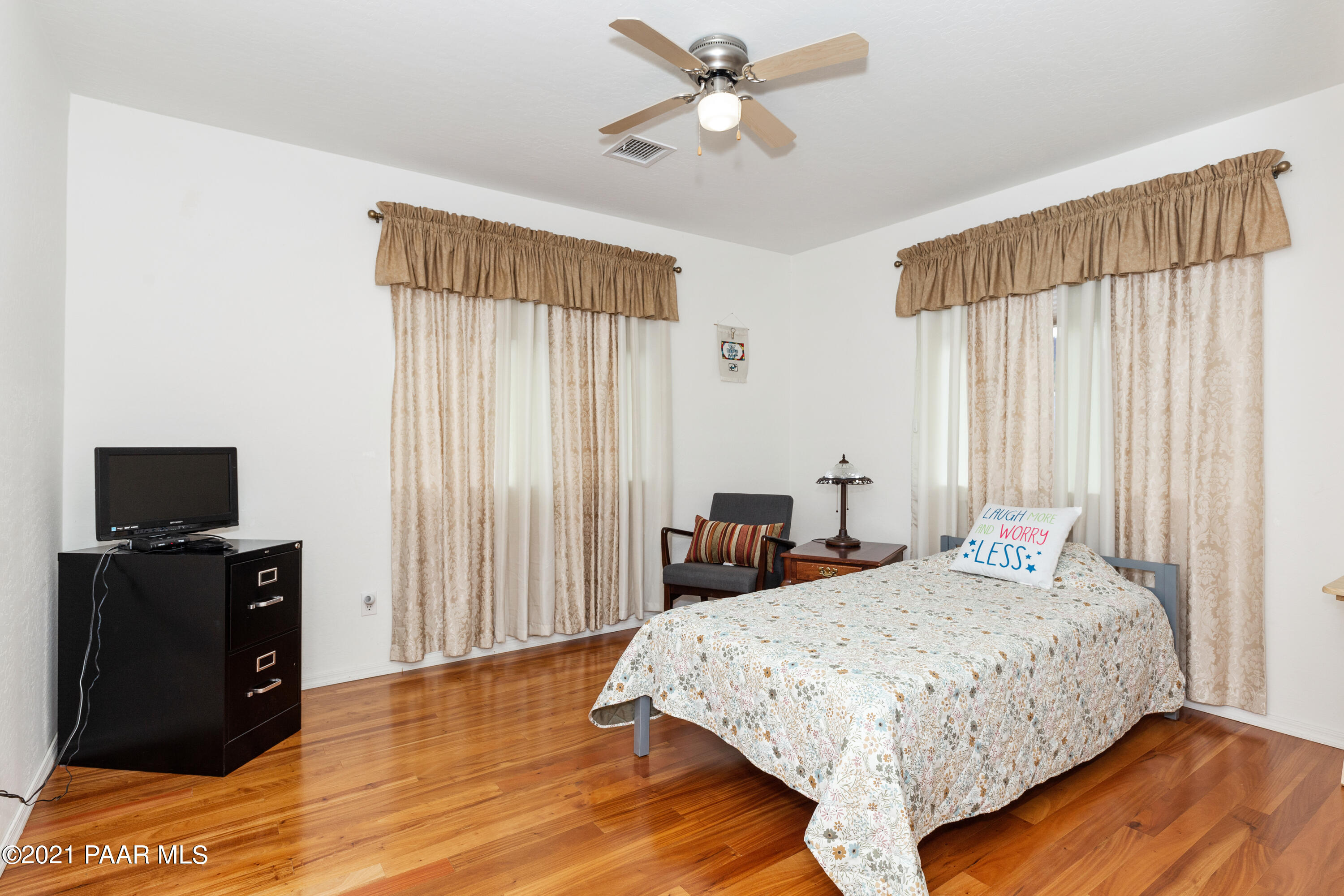 1654 St Andrews Way Prescott, AZ 86301 - Photo 15 of 29 a bedroom with a bed and wooden floor