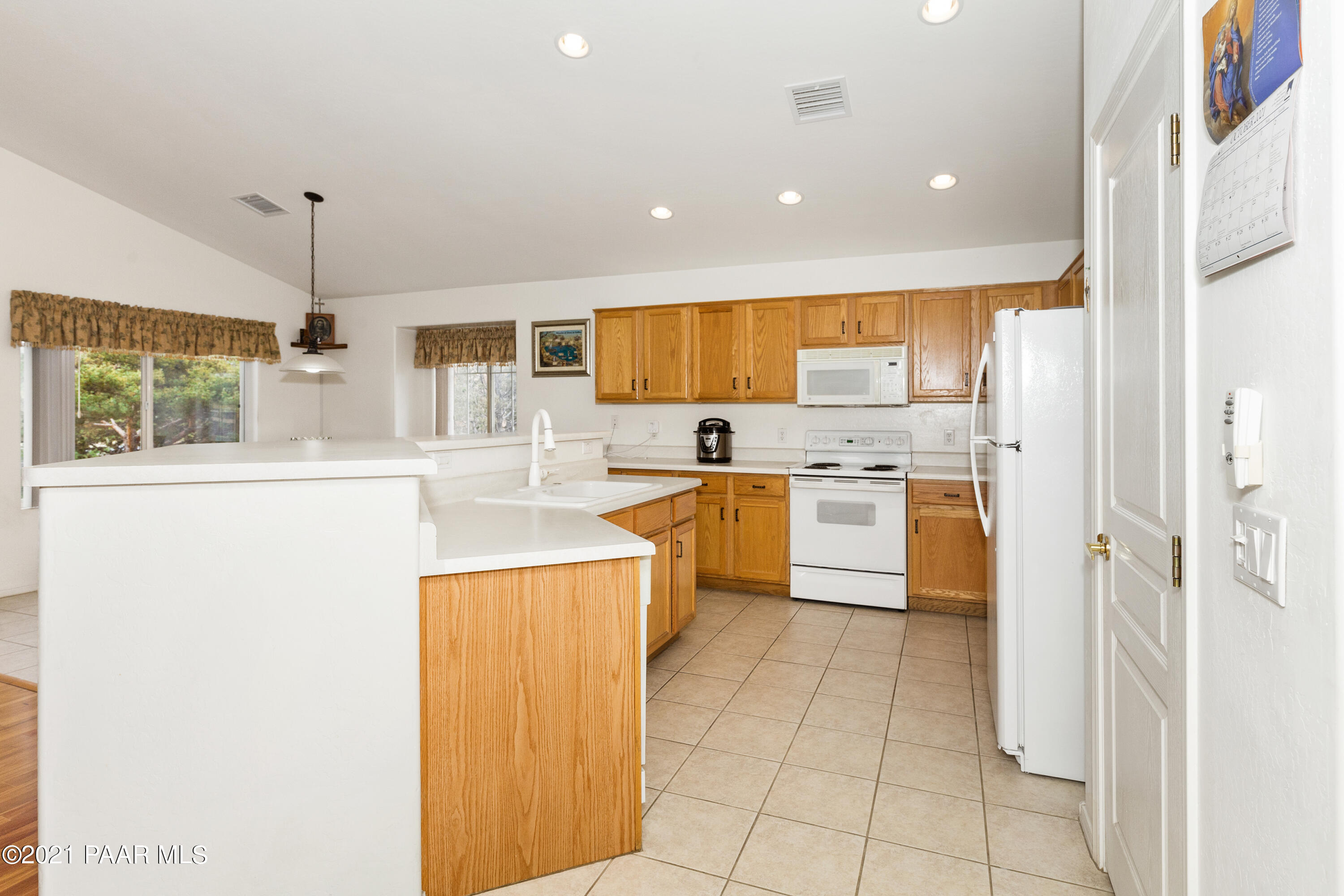 1654 St Andrews Way Prescott, AZ 86301 - Photo 9 of 29 a kitchen with a sink a counter top space stainless steel appliances and cabinets