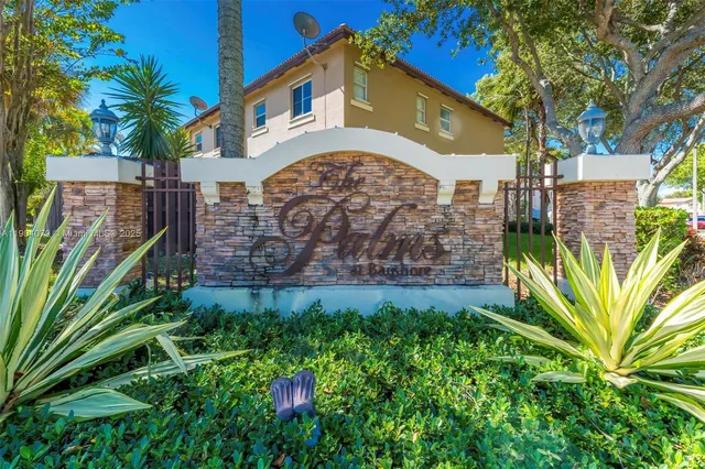 a view of a palm trees front of house