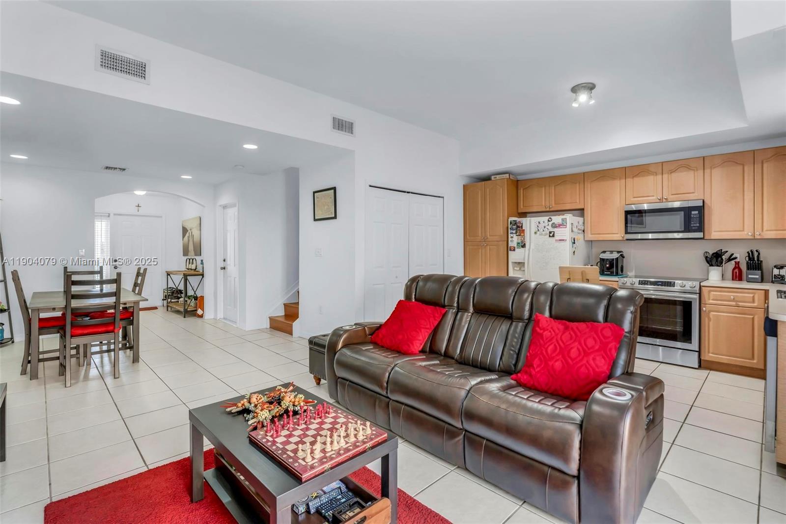 22232 Southwest 88th Path Cutler Bay, FL 33190 - Photo 11 of 72 a living room with furniture and a open kitchen area