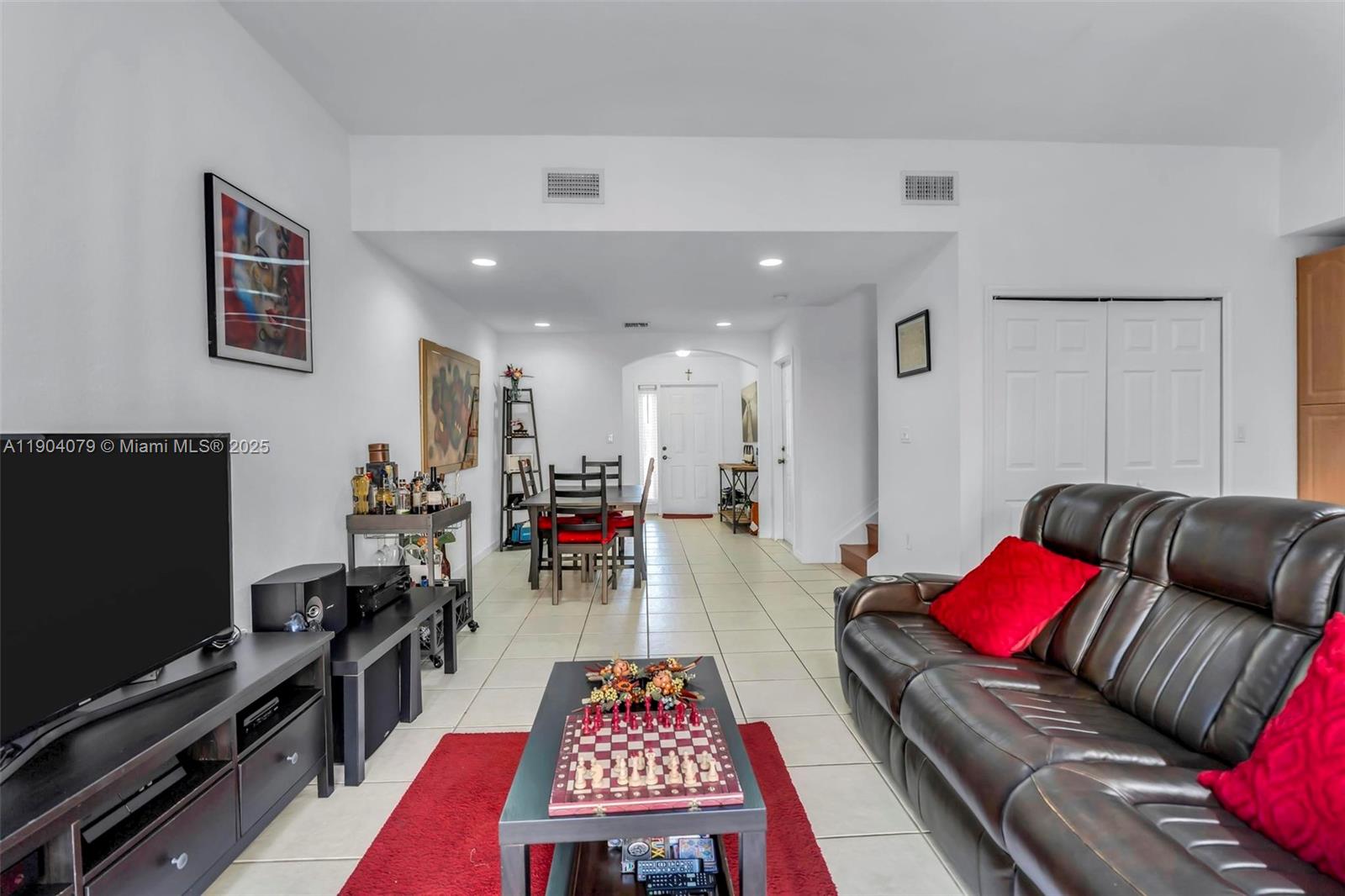22232 Southwest 88th Path Cutler Bay, FL 33190 - Photo 12 of 72 a living room with furniture and a flat screen tv