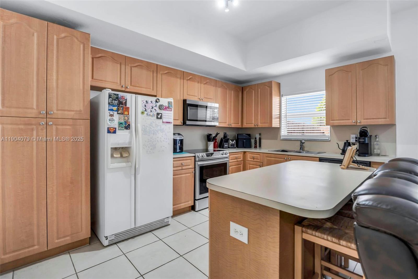 22232 Southwest 88th Path Cutler Bay, FL 33190 - Photo 13 of 72 a kitchen with stainless steel appliances granite countertop a refrigerator sink and cabinets