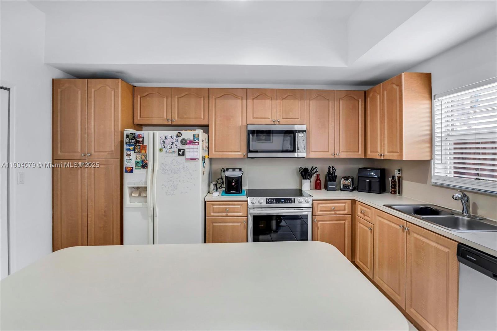 22232 Southwest 88th Path Cutler Bay, FL 33190 - Photo 15 of 72 a kitchen with stainless steel appliances granite countertop a refrigerator stove and a sink