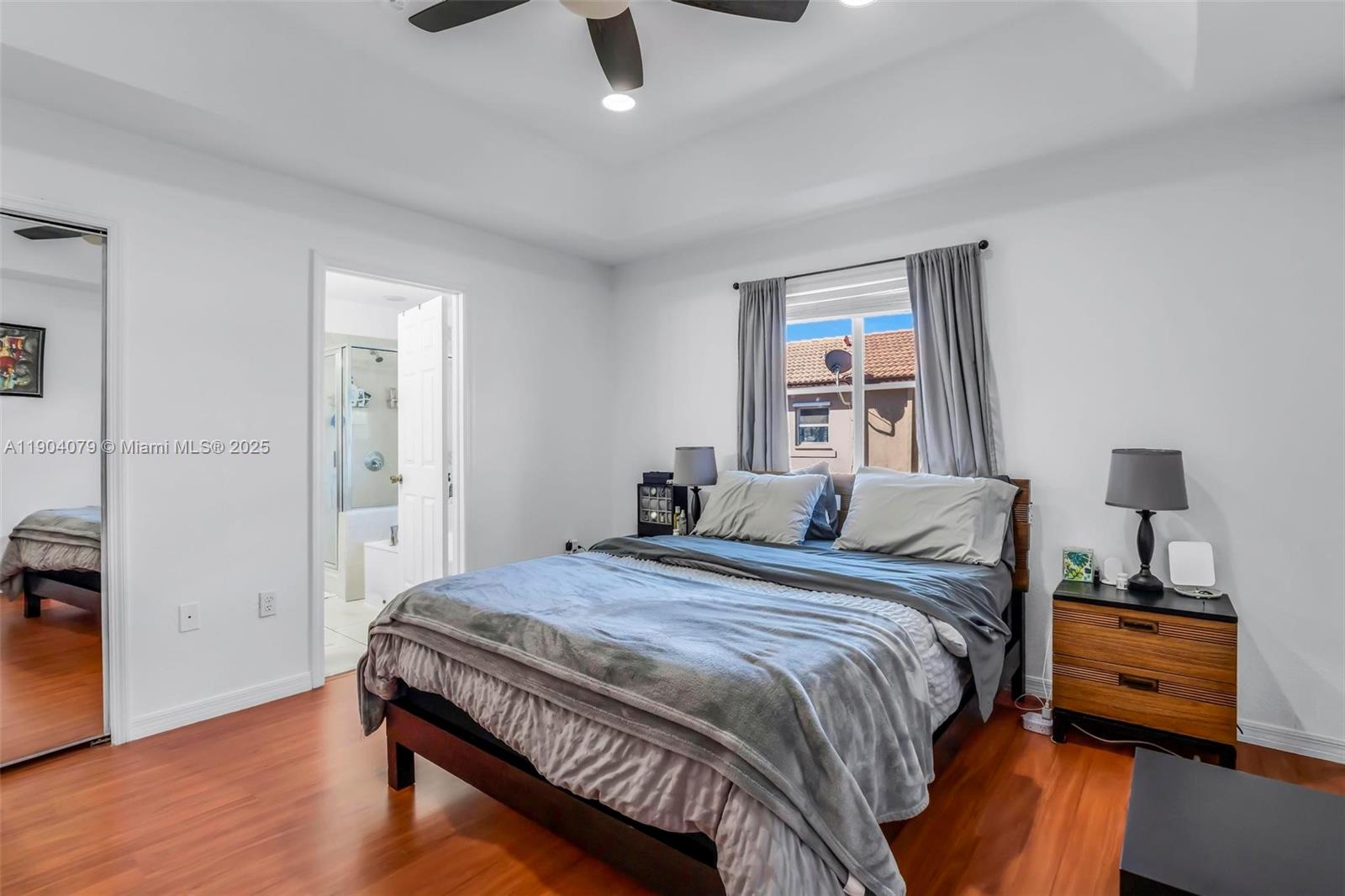 22232 Southwest 88th Path Cutler Bay, FL 33190 - Photo 21 of 72 a bedroom with a bed and wooden floor