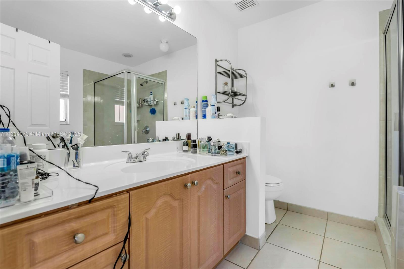 22232 Southwest 88th Path Cutler Bay, FL 33190 - Photo 23 of 72 a bathroom with a sink and a mirror