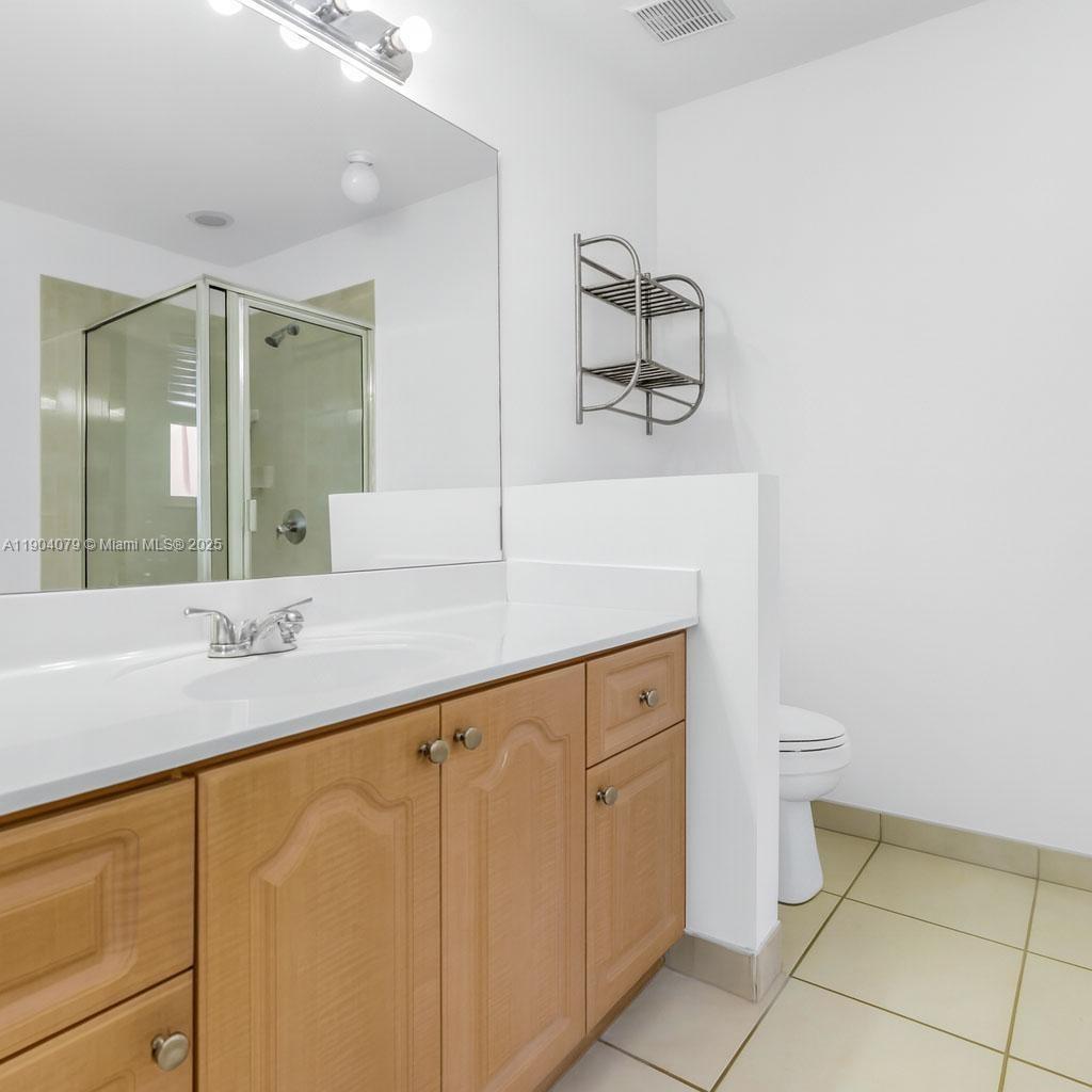 22232 Southwest 88th Path Cutler Bay, FL 33190 - Photo 24 of 72 a bathroom with a sink a toilet and mirror