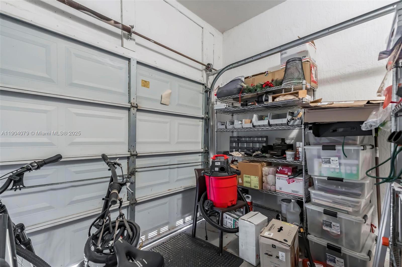 22232 Southwest 88th Path Cutler Bay, FL 33190 - Photo 32 of 72 a storage room with water heater and racks