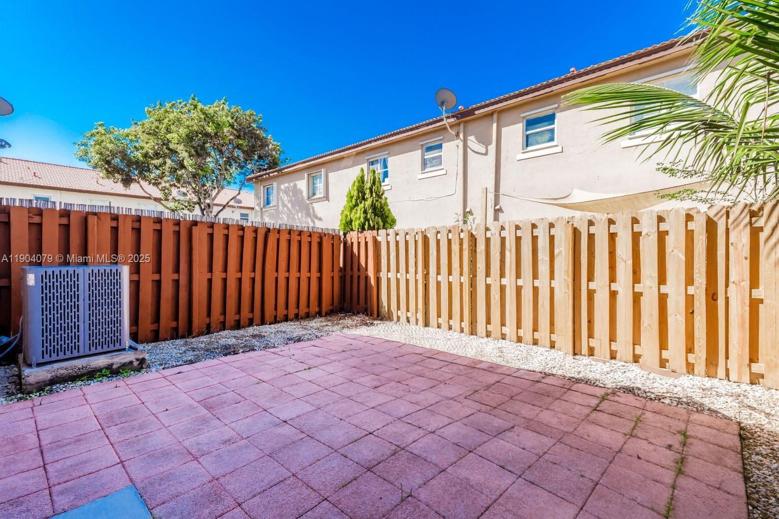 22232 Southwest 88th Path Cutler Bay, FL 33190 - Photo 34 of 72 a front view of a house with a garden