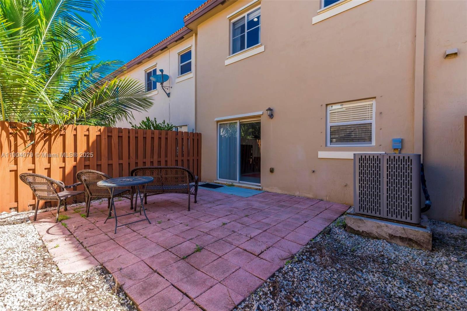 22232 Southwest 88th Path Cutler Bay, FL 33190 - Photo 35 of 72 a view of a backyard with a patio and outdoor seating