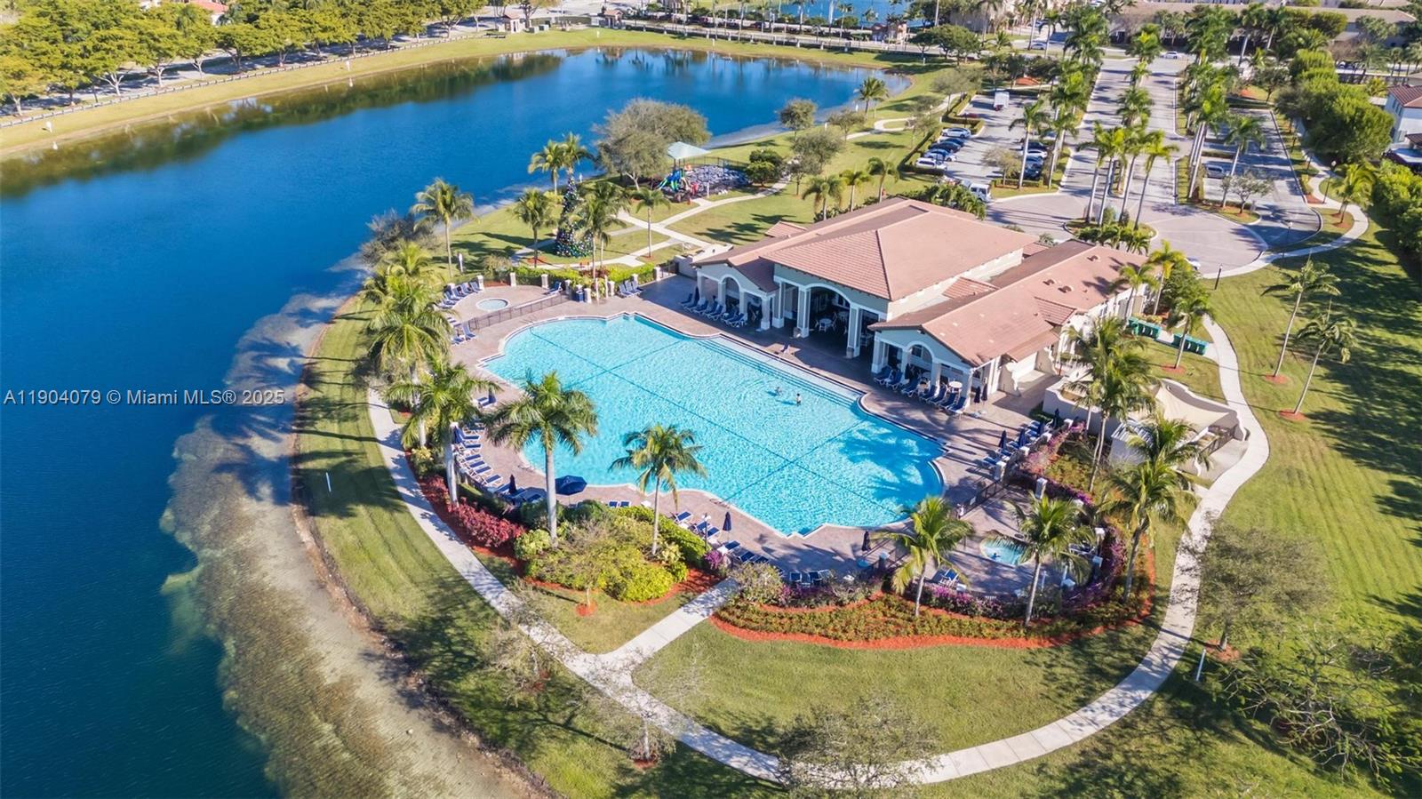 22232 Southwest 88th Path Cutler Bay, FL 33190 - Photo 66 of 72 an aerial view of a house with a swimming pool yard and lake view