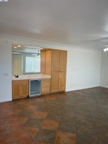 a view of an empty room with a fireplace and a window