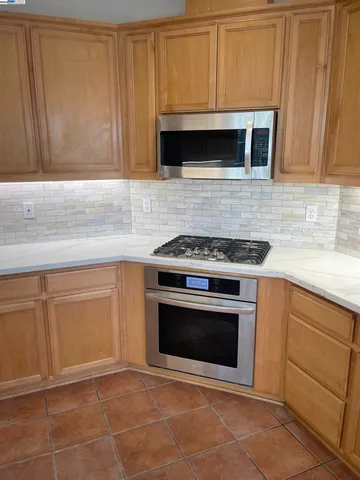 a kitchen with granite countertop white cabinets stainless steel appliances and sink