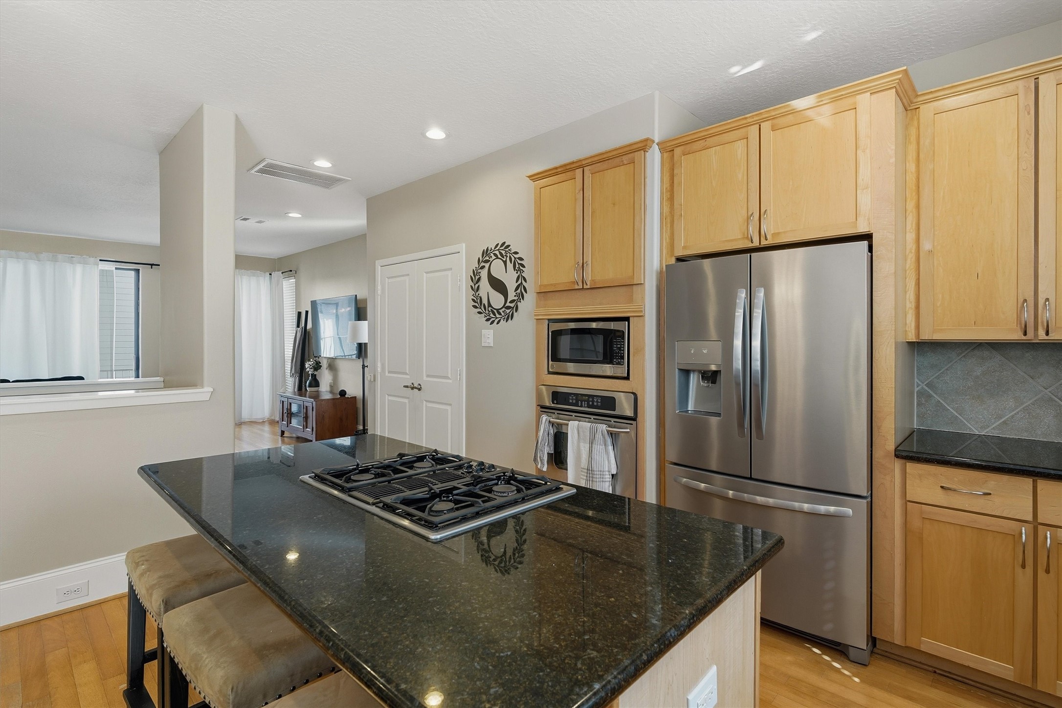 2529 Rusk Street Houston, TX 77003 - Photo 7 of 23 Kitchen with granite countertops, gas cooktop, and island seating