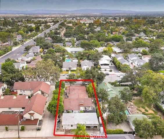 an aerial view of residential houses with outdoor space