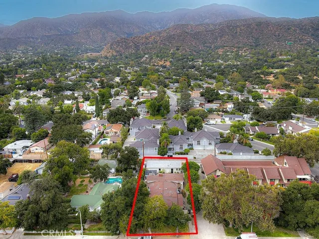 an aerial view of residential houses and outdoor space
