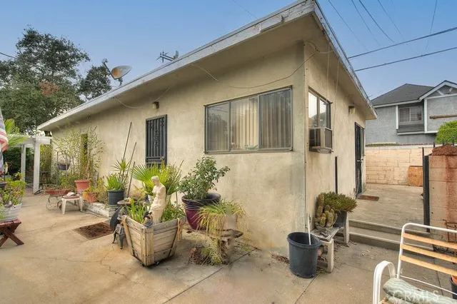 a view of a patio with couches and potted plants