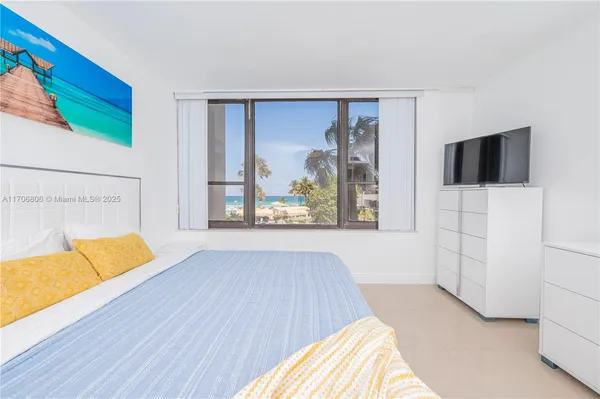 a view of a bedroom with wooden floor