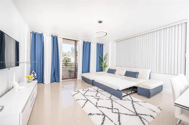 a living room with furniture and large windows