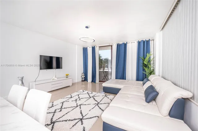 a bedroom with a large bed and a potted plant