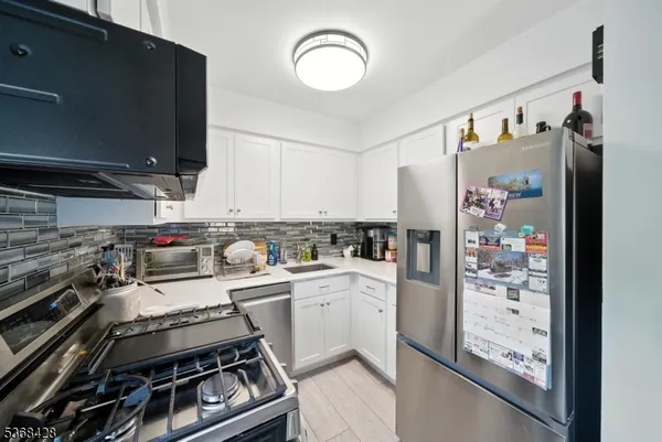 a kitchen with a stove and a refrigerator