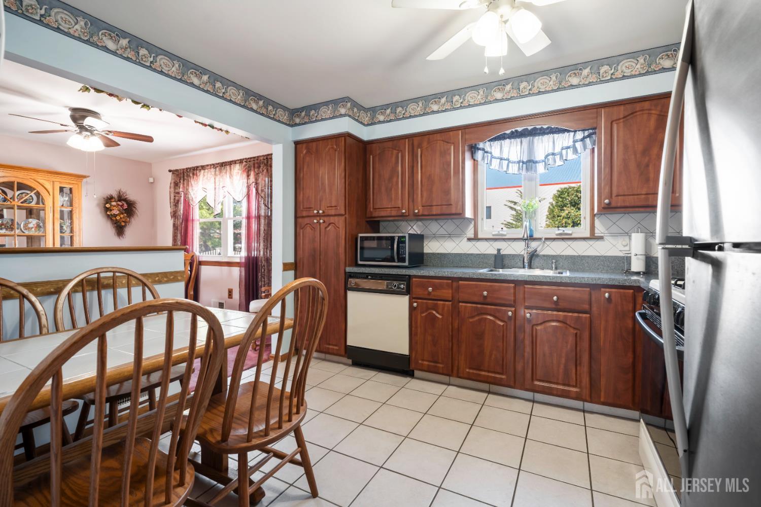 6 Marie Lane Edison, NJ 08817 - Photo 13 of 35 a kitchen with stainless steel appliances granite countertop a stove a sink a dining table and chairs