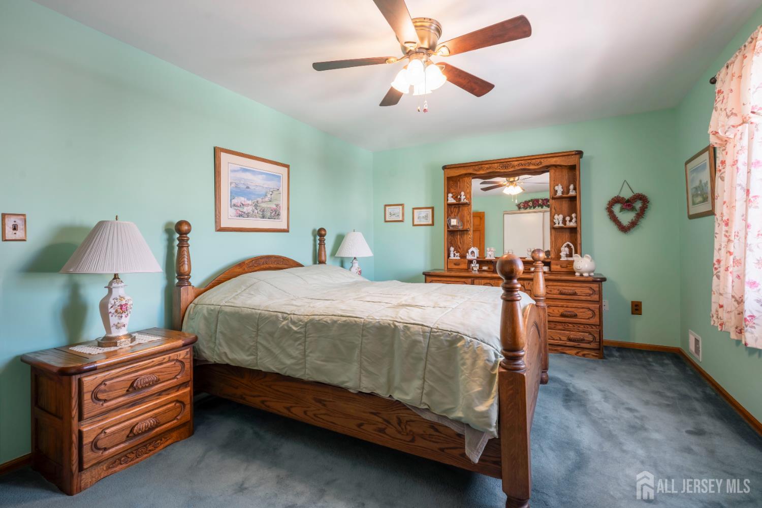 6 Marie Lane Edison, NJ 08817 - Photo 18 of 35 a bed room with a bed and a chandelier