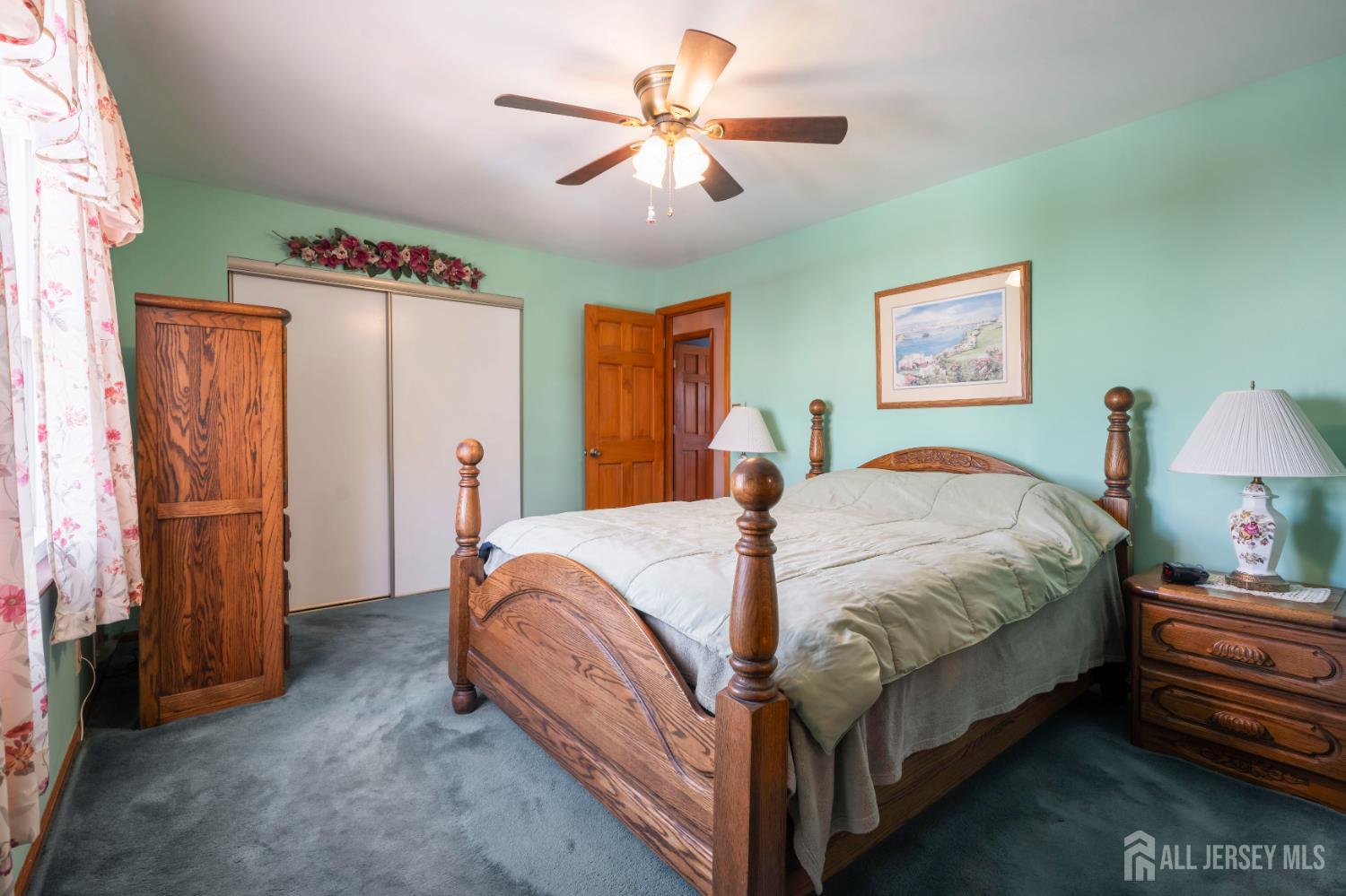 6 Marie Lane Edison, NJ 08817 - Photo 19 of 35 a bed room with a bed and a chandelier