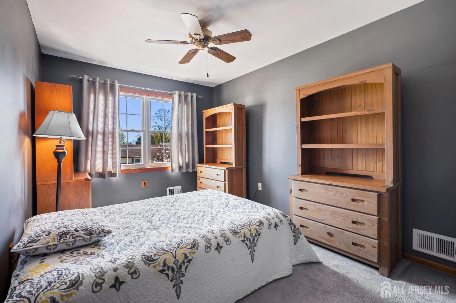 6 Marie Lane Edison, NJ 08817 - Photo 22 of 35 a bedroom with a bed a dresser and a chandelier