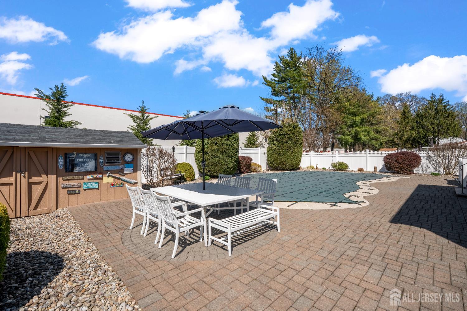 6 Marie Lane Edison, NJ 08817 - Photo 31 of 35 a view of a patio with a dining table and chairs with a barbeque grill and a fireplace