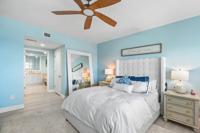 a bedroom with a large bed and a chandelier