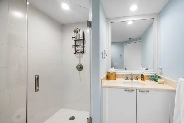 a bathroom with a shower and a sink