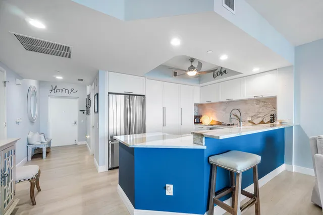 a kitchen with white cabinets and white appliances