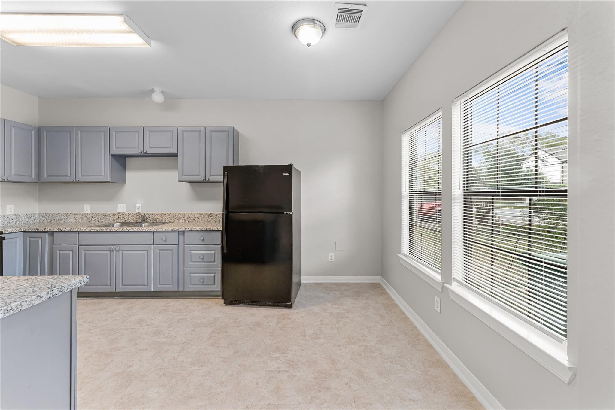9610 Buffum Street, Unit B Houston, TX 77051 - Photo 5 of 25 a kitchen with a refrigerator and a sink