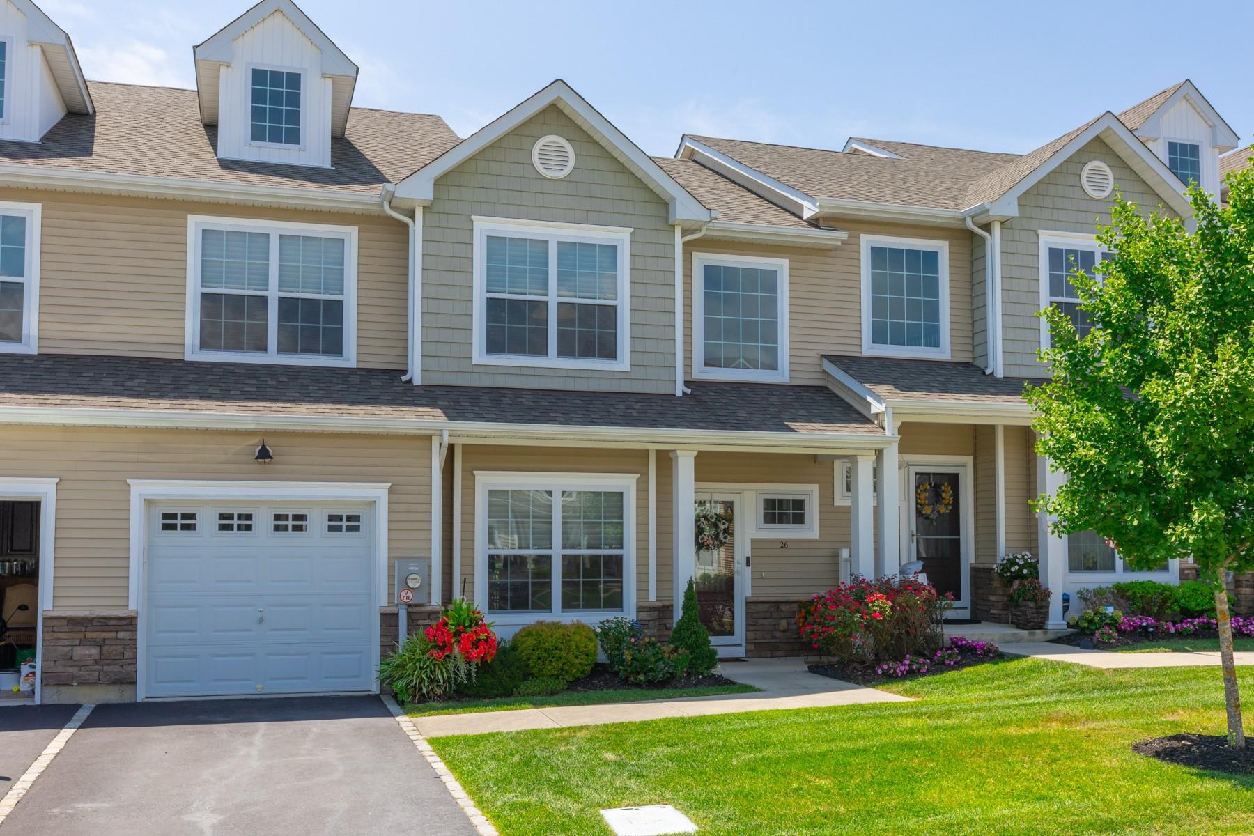 front view of a brick house with a yard