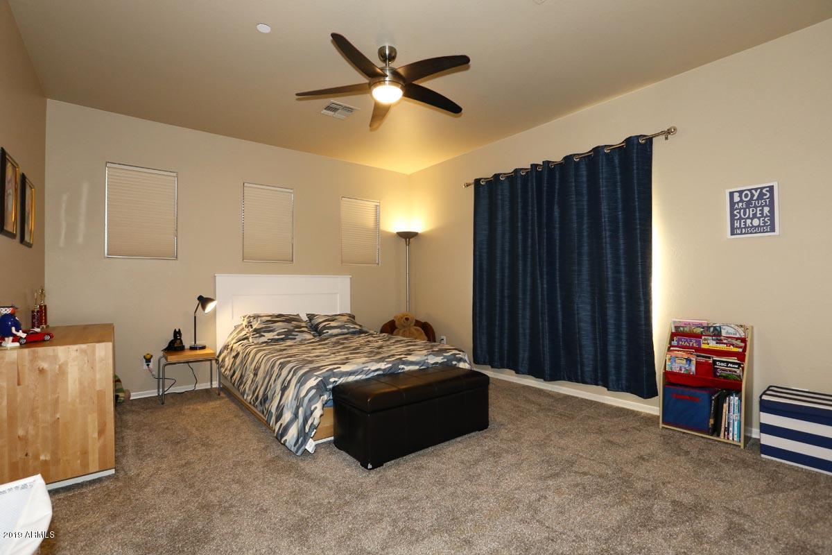 3736 East Maffeo Road Phoenix, AZ 85050 - Photo 38 of 62 a bedroom with a bed and a chandelier
