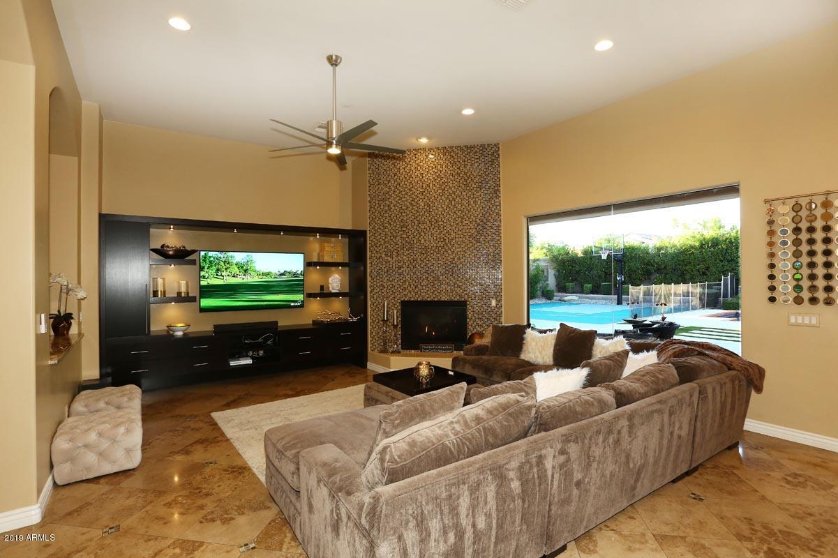 3736 East Maffeo Road Phoenix, AZ 85050 - Photo 54 of 62 a living room with furniture and a flat screen tv