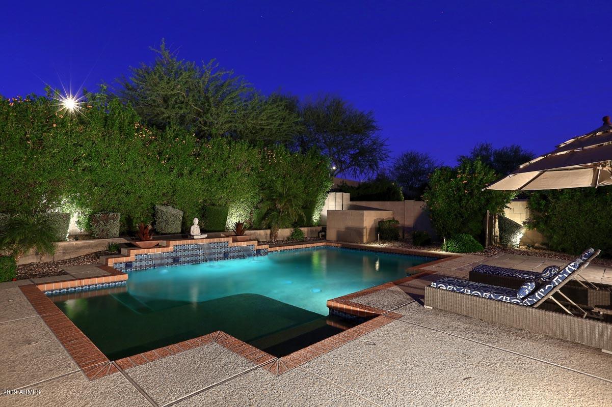 3736 East Maffeo Road Phoenix, AZ 85050 - Photo 9 of 62 a view of a swimming pool with lawn chairs under an umbrella
