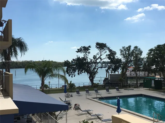 a view of a swimming pool with a patio and a garden