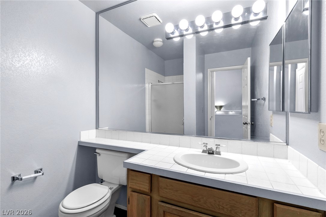 6250 West Flamingo Road, Unit 98 Las Vegas, NV 89103 - Photo 20 of 40 Full bath featuring toilet, a stall shower, and vanity